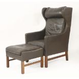 A brown leather high back armchair,with matching ottoman (2)