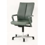 A contemporary Hülsta desk chair, with green leatherette upholstery