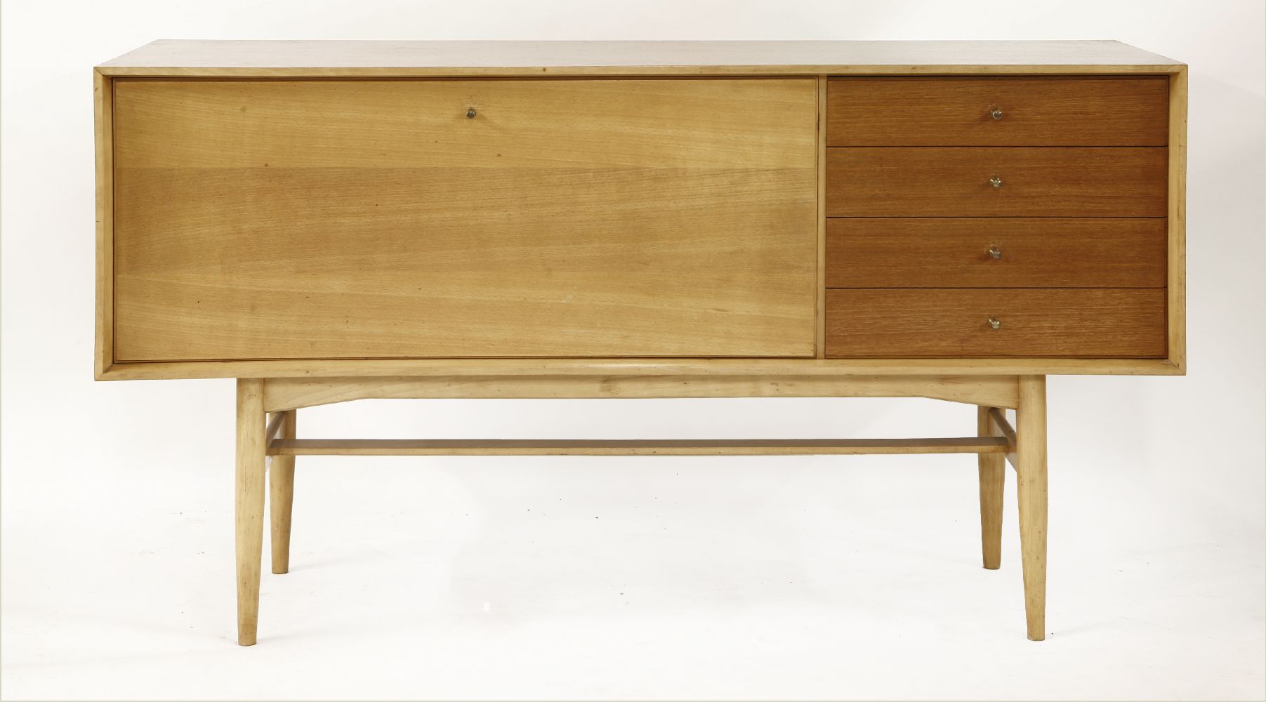 An Heal's teak and oak sideboard,with a hinged drop cabinet and four drawers, with Heal's label to