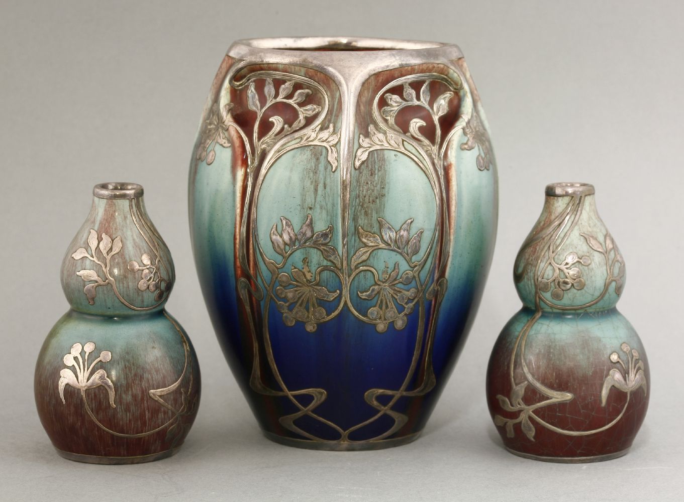 A garniture of Art Nouveau vases,in the manner of Alphonse Cytete, early 20th century, each with