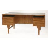 A Danish teak desk,designed by Vald Mortensen for Odense Møbler, with a raised top, three drawers