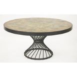 A tile top table,the circular top inset with tiles painted with silhouettes of autumnal leaves, on a