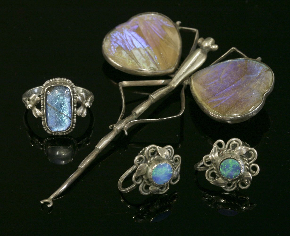 A pair of Arts and Crafts black opal doublet earrings,each one with a circular black opal doublet
