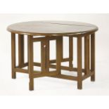 A Cotswold walnut drop-leaf table, the ends and gatelegs with vertical cut designs, 91.5cm long91.