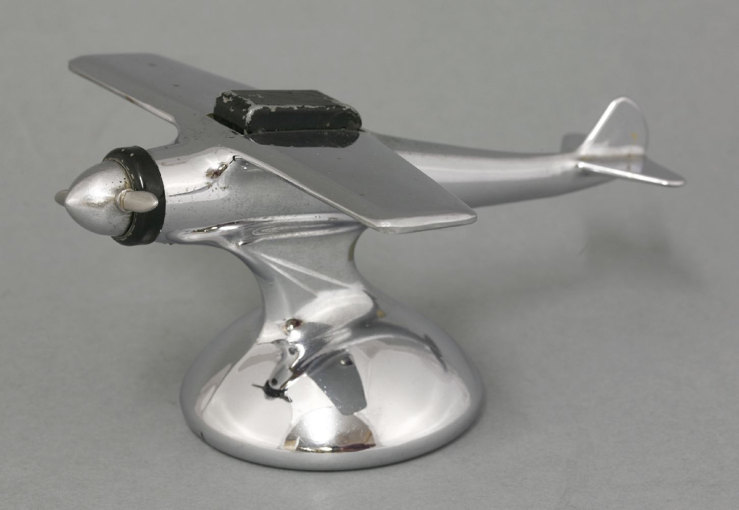 A chrome plane table lighter,with the propeller activating the lighter opening, the cockpit labelled