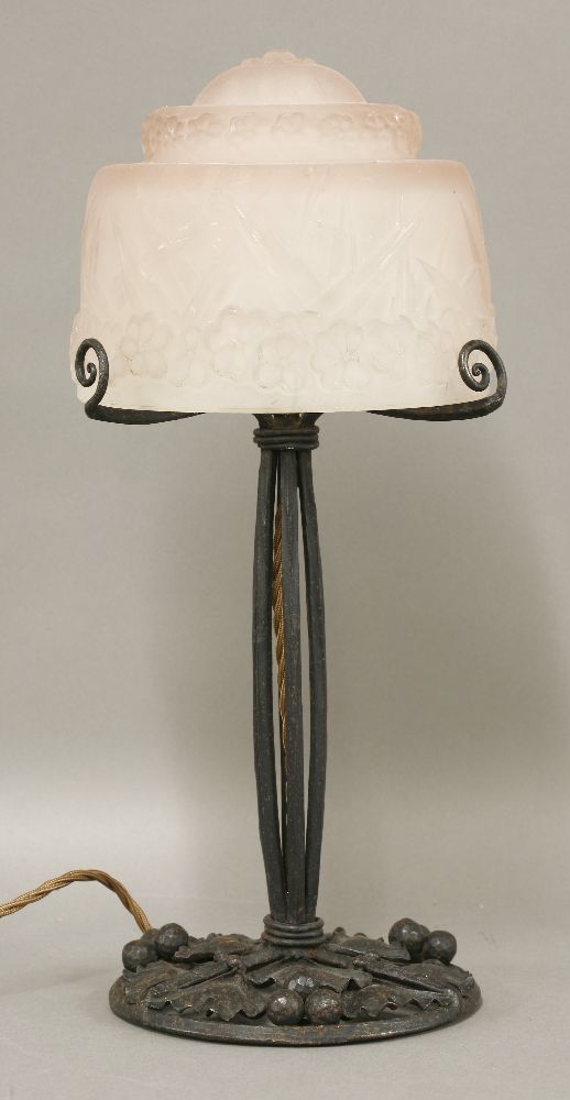 A French Art Deco table lamp,the moulded pink glass shade signed 'Muller Frères Luneville', raised