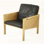 An oak armchair,designed by Kai Kristiansen for Christian Jensen Mobelsnedkeri, with a wicker back