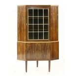 A Danish rosewood corner cupboard,the top with a panelled glass door over another cupboard,85.5cm