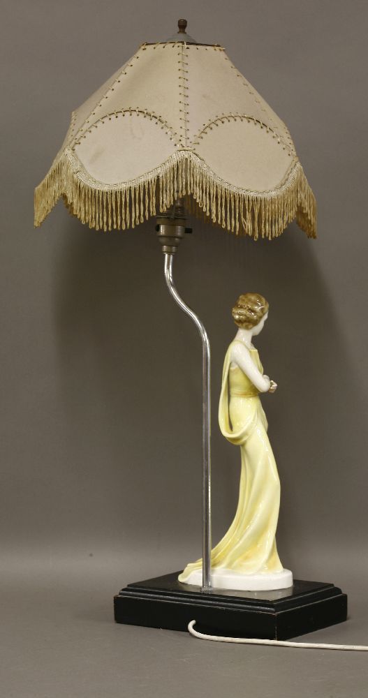 An Art Deco pottery table lamp,modelled as a lady in a yellow dress, on an ebonised plinth, with a - Image 2 of 2