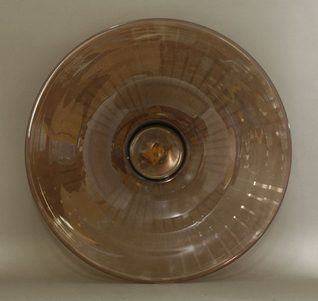 A Schneider amethyst glass charger,etched with a stylised sunburst pattern, silver label 'Objets d'