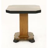 An Art Deco octagonal walnut lamp table,with an ebonised edge, a square column, on a canted plinth