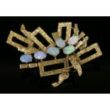 A Continental gold opal brooch, c.1970,with radiating rectangular frames, each frame with bark