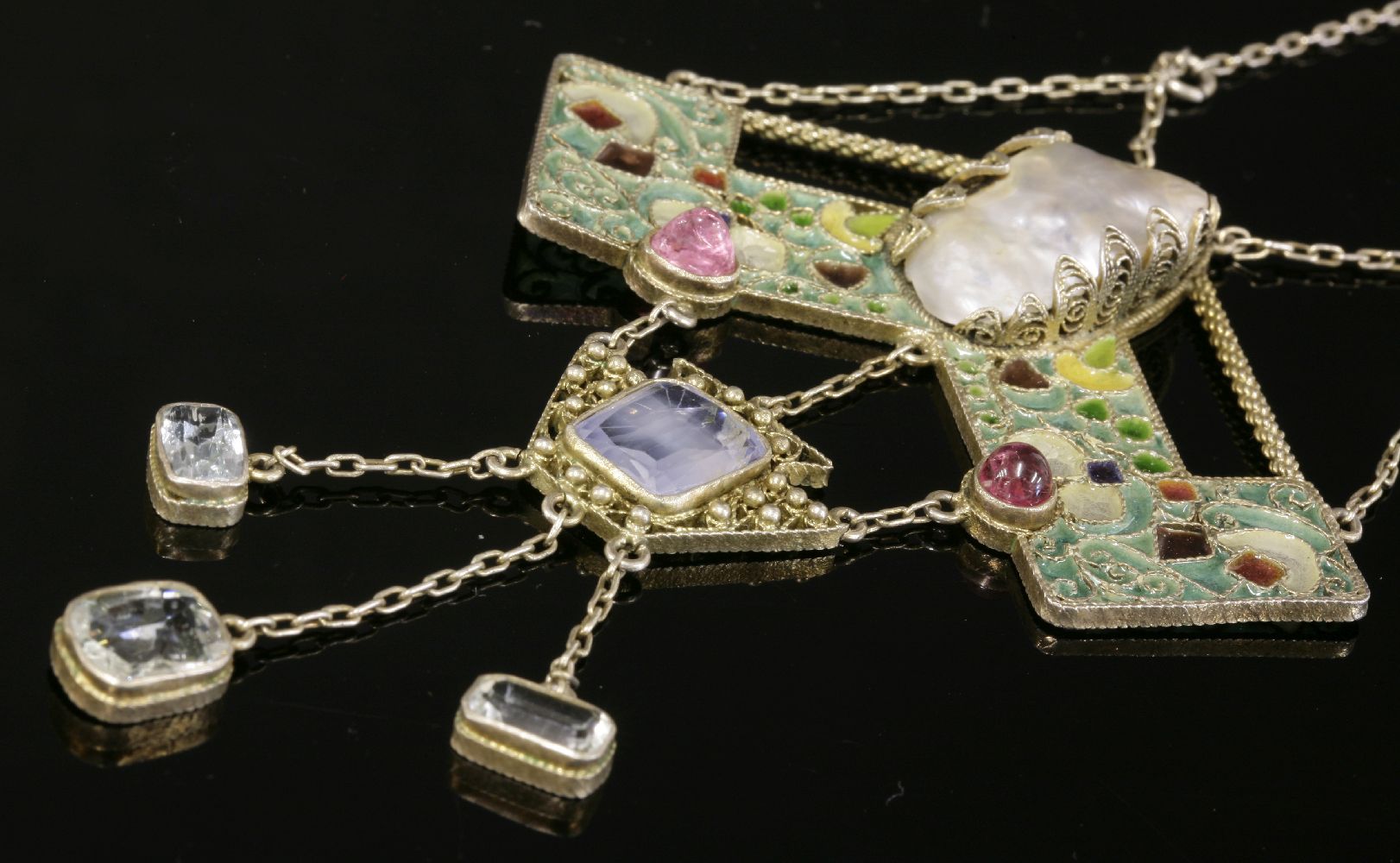 An Arts and Crafts silver gilt, blister pearl, pink tourmaline, sapphire, aquamarine and plique-à-
