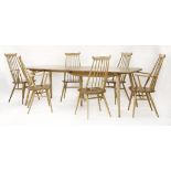 An Ercol table,with two extra hinged leaves,226cm extended84cm wide71cm high, andfour elbow chairs