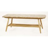 An Ercol coffee table,the shaped rectangular top over a slatted undertier, 104cm long46cm wide36cm