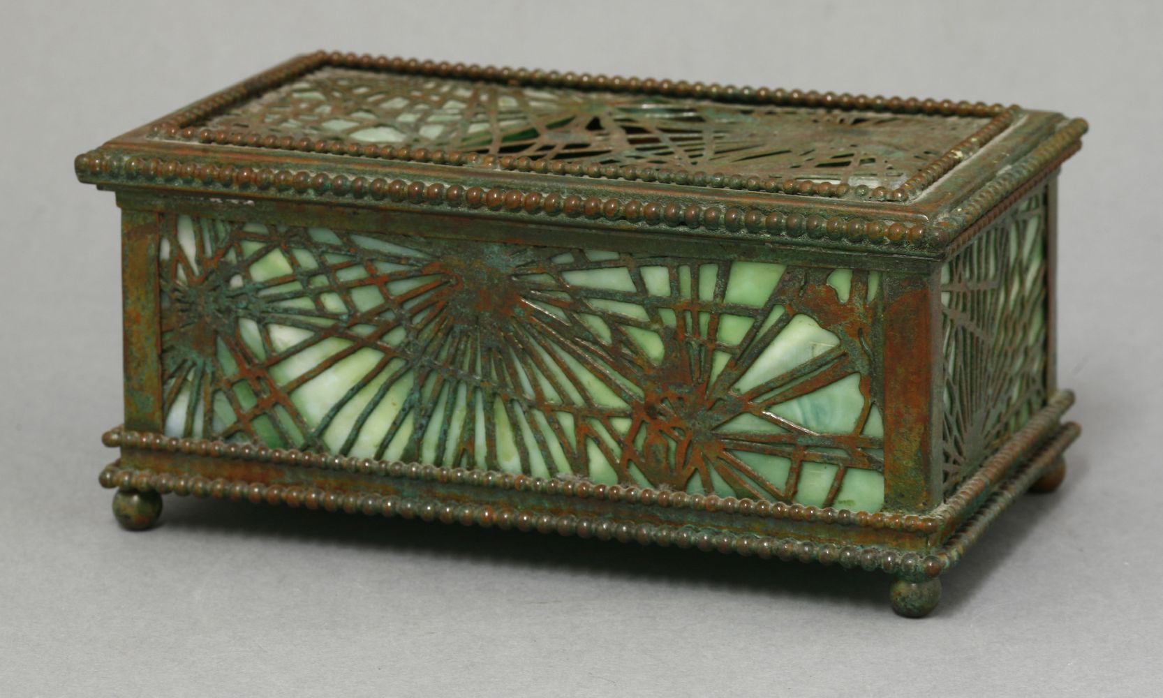 A Tiffany Studios' gilt brass and glass pierced casket,the pierced web panels with a beaded - Image 2 of 4