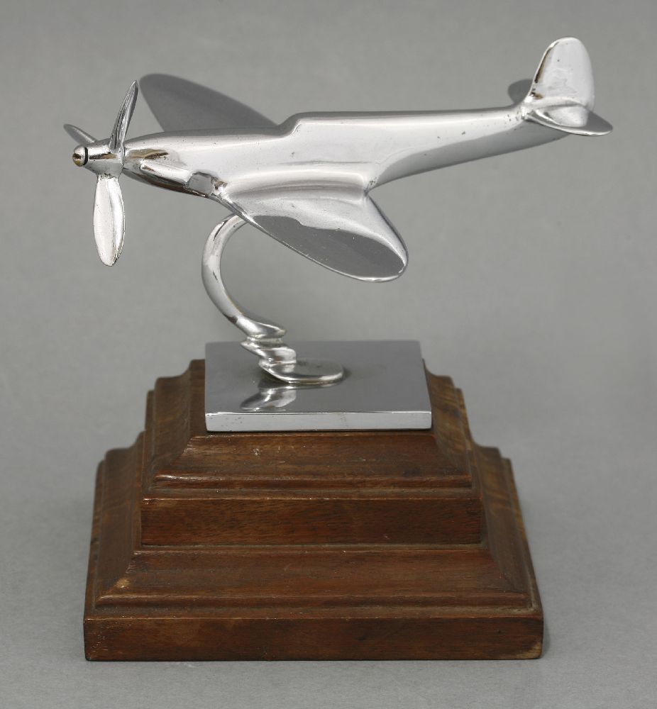 A chrome Spitfire desk model,on a mahogany plinth,13cm high