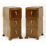 A pair of Art Deco walnut pot cupboards,each with three drawers with Bakelite handles, raised on