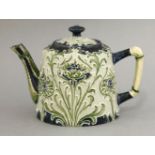 A MacIntryre 'Florianware' teapot,tube lined with flower heads in shades of green, blue and