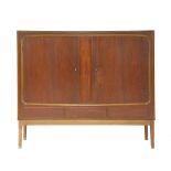 A Danish teak high sideboard,the cupboard opening to reveal three baize-lined drawers and further