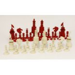 A bone chess set, early 20th century, natural and stained red, king 11.5cm high
