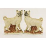 A pair of Staffordshire pottery Mastiff Dogs, c.1880, each strongly modelled with ochre tinged body,