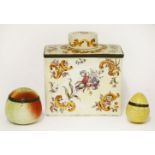 An enamel tea caddy and cover,19th century, painted with flowering foliage on a pale ground,12cm