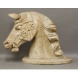 A Victorian carved pine horse head,with bridle, on an oval mount,63cm high
