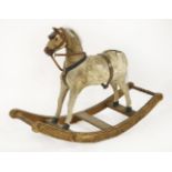 A carved pine, painted and ponyskin small bow rocking horse,19th century, fitted with a leather