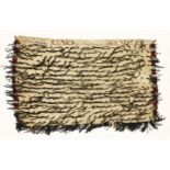 A Maori Korowai cloak,19th century, with a black 'hukahuka' (tasselled) lower border and and