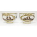 A pair of Meissen Tea Bowls,c.1740, each decorated with two gilt reserved panels depicting a