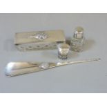 A silver lidded pin box, pepperette, a button hook, and scent bottle