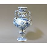 A Delft urn, painted with lion masks, 19.5cm high