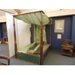 A mahogany four poster bed, with curtains and headboard