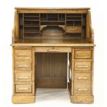 An early 20th century American oak 'S' tambour roll top desk, the brass escutcheon stamped 'Derby