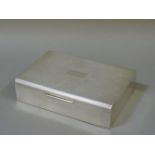 A silver table top cigarette box, Birmingham 1966, with an engine turned cover, 17cm wide