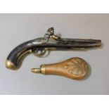 An early 19th century flintlock pistol, with brass mounts and trigger guard, 34cm, and an embossed