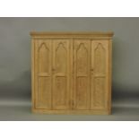 A large pine Gothic style hanging wall cabinet