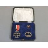 A 2nd class iron cross, German U boat war badge, and a veteran badge, in presentation box