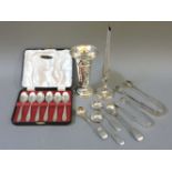 A boxed set of six silver teaspoons, silver condiment spoons, tongs, etc