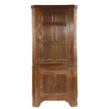 An Irish mahogany standing corner cupboard, with two panelled doors, 110cm wide, 237cm high