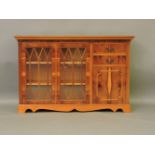 A reproduction yew wood bookcase, 148cm wide