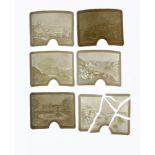 A set of five lithophanes, each curved and with landscapes, and another, broken