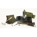 Military items, including a Commando knife, a rocket tail inkstand, a belt, a spoon with swastika,