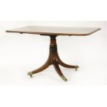 A Regency period mahogany breakfast table, with crossbanded tilt top, on a column and four sabre