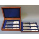 A cased set of twelve ivory handled fish knives, with silver plated mounts and blades, with engraved