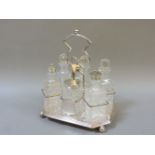 A silver plated condiment stand, and six bottles