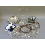 A collection of silver items, including two card cases, souvenir spoons, napkin rings, a