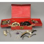 A red leather jewellery box, containing a collection of ladies wristwatches, a silver pendant on a