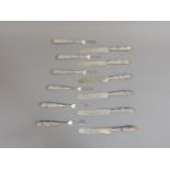 A set of six ornate white metal Burmese knives and forks, 830g